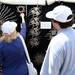 Shoppers examine a metal piece at artists' Ron Schmidt and Bob Motherson's booth during the Guild's Ann Arbor Summer Art Fair on Thursday, July 18, 2013. Melanie Maxwell | AnnArbor.com